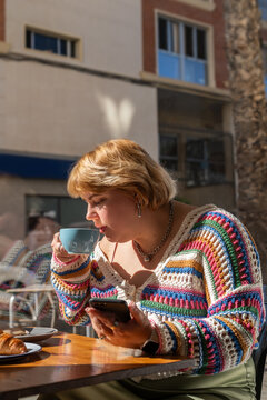 Woman drinking coffee at cafe