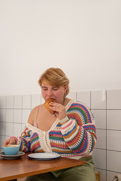 Woman biting croissant