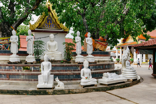 Buddha statues in various attitudes in a temple courtyard in Thailand