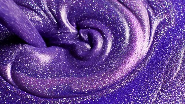Closeup of swirling, thick, vibrant purple glitter cosmetic or slime texture with high sparkle and iridescent highlights