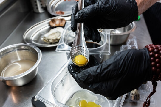 Chef Prepares Delicate Quail Eggs for Gourmet Dish at Culinary Event