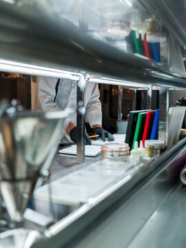 Chef doing paperwork in restaurant kitchen 