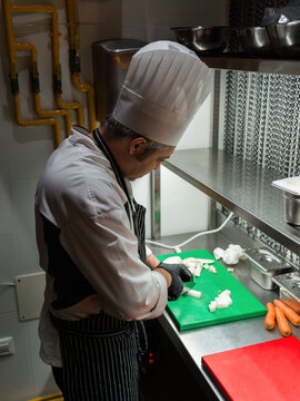 Chef Prepares Vegetables in a Professional Kitchen During Service