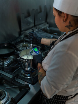 Chef controlling temperature while cooking 