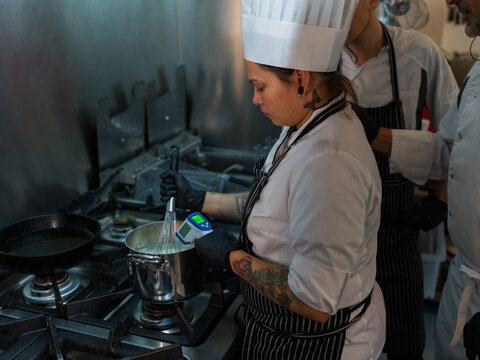 Chef checking temperature while cooking 