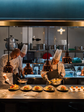 Group of chefs preparing gourmet dishes in restaurant 