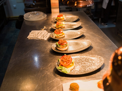 Gourmet cheeseburgers on plates 