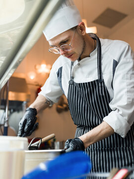 Young chef cooking in kitchen 