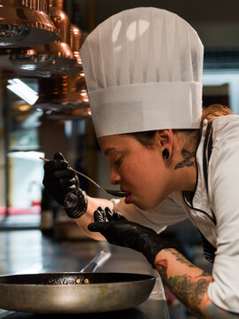 Chef trying food while cooking