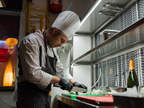 Focused chef cutting ingredients 