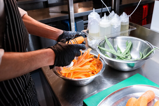 Cook peeling carrots 