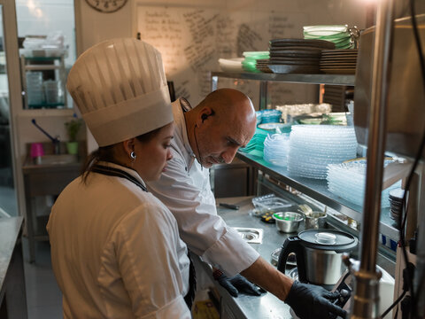 Focused chef using food processor 
