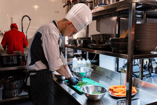 Professional Chef Prepares Fresh Vegetables in Kitchen