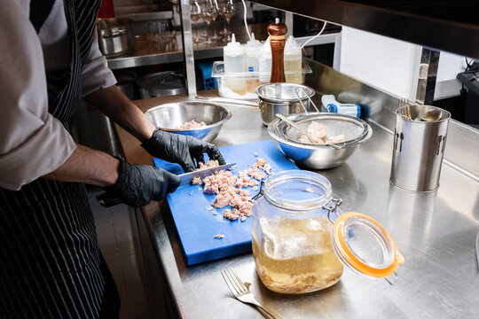 Cook chopping marinated chicken 