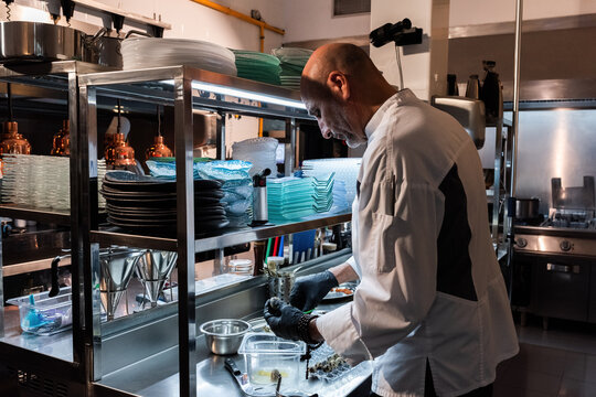 Chef opening quail eggs 