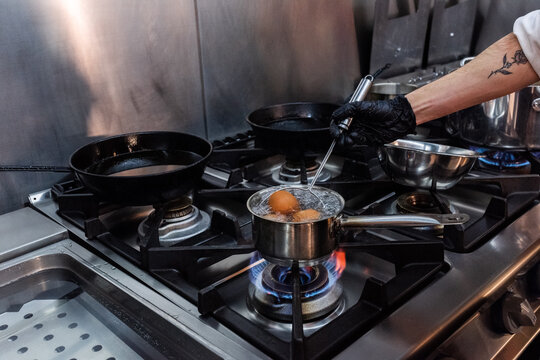Cooking Eggs on a Stove in a Professional Kitchen Setting