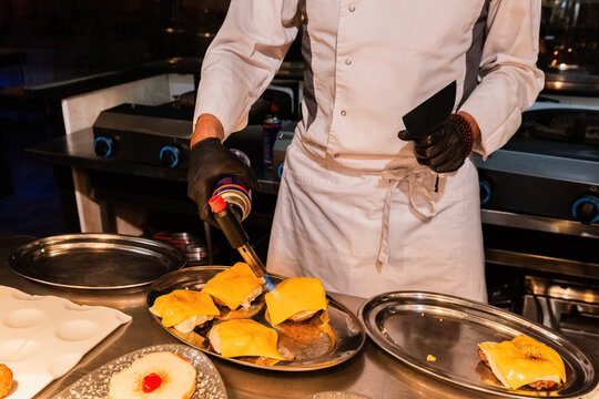 Anonymous chef making gourmet cheeseburger