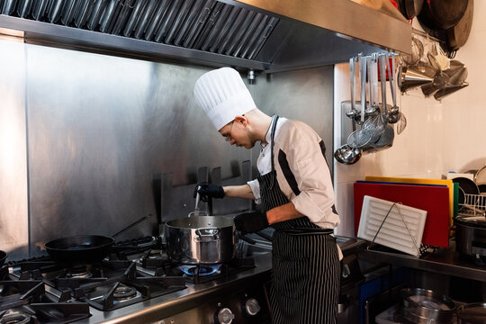 Cook checking readiness of potato