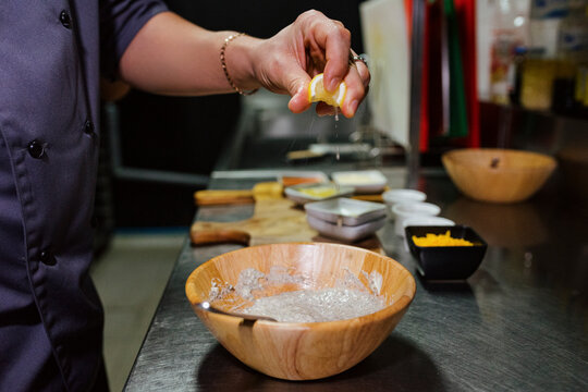 Chef mixing sauce in a kitchen