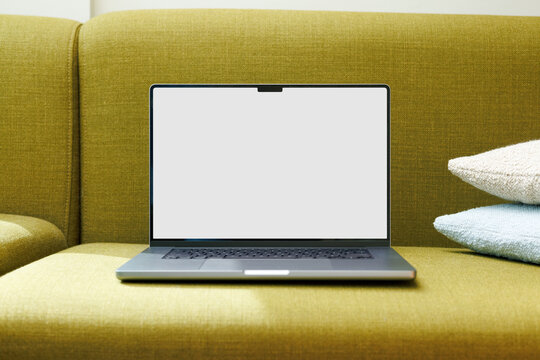Laptop Mockup with White Screen on Cozy Sofa
