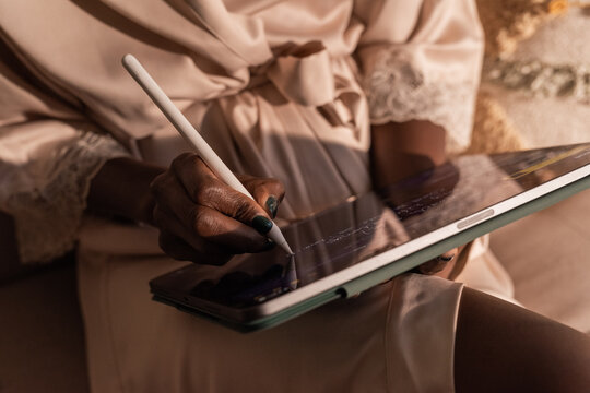 Writing With a Stylus on a Tablet in a Cozy Setting