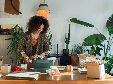 Woman packing goods for shipment 
