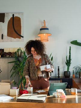 Happy entrepreneur preparing goods