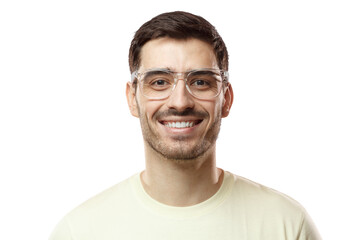 Obraz premium Close up shot of smiling attractive man in biege t-shirt and trendy trasparent eyeglasses isolated on pink background