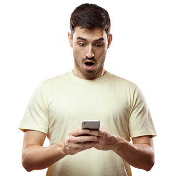 Close up portrait of handsome young man in beige t-shirt, holding smartphone, looking scared and confused reading text message or e-mail