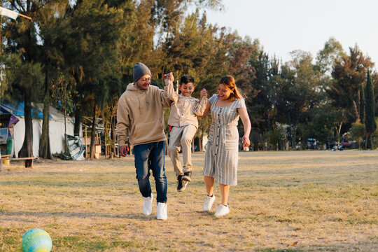 Family Jump Hold Hands Park