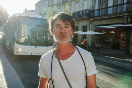 Standing on the Street Near a Bus 
