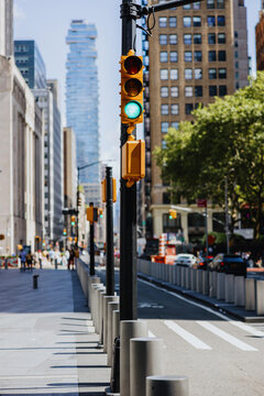 Green traffic light on city street with buildings