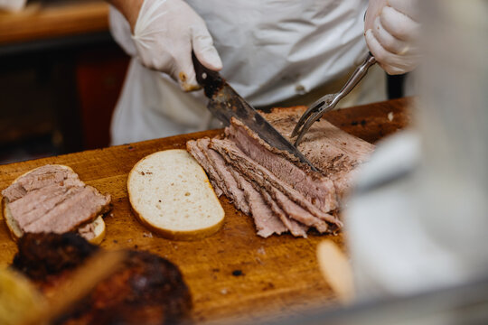 Slicing Tender Roast Beef at a Deli Restaurant in the Afternoon