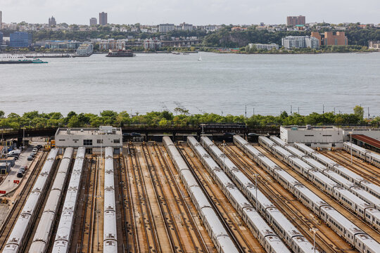 Train yard beside waterfront with city backdrop