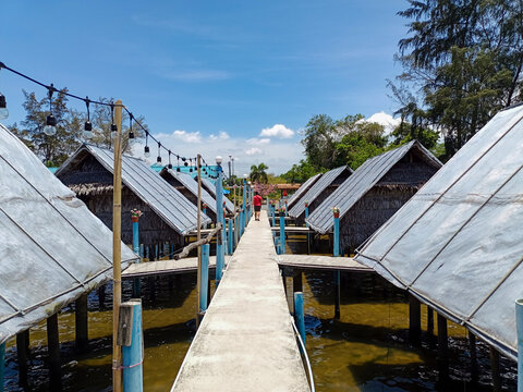 Seaside Huts Along a Walkway in Bright Daylight