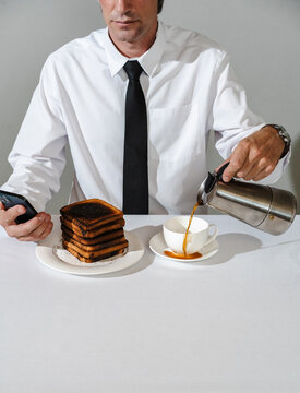 Man pouring coffee while distracted by phone