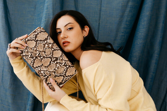 Woman holding snake print 