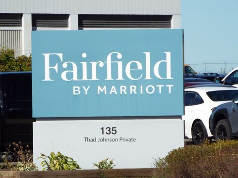 Ottawa, ON, Canada-July 12,2025: A light blue "Fairfield by Marriott" sign stands at 135 Thad Johnson Private near a parking lot.