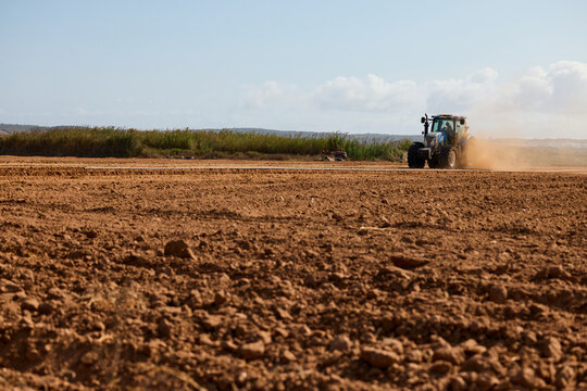 Tractor Plowing Dry Rocky Field