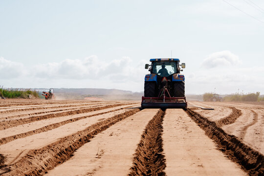 Tractor Creating Furrows on Farmland