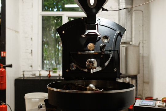 Large coffee roaster full of coffee beans during work in workshop
