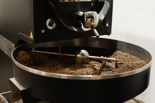Coffee beans from coffee roaster being poured into cooling cylinder