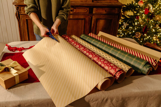 Cutting Wrapping Paper for Gift Packaging During Christmas Holidays