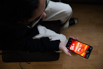 Person Holding Phone with Redes Sociales Plus 16 Restriction in Spain, Conceptual Image of New Spanish Law Restricting Social Media for Minors