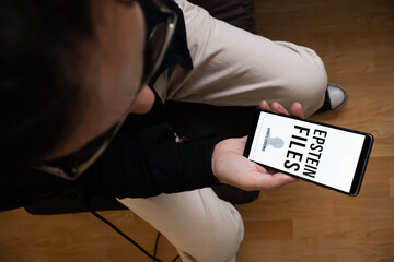 Mobile Screen Displaying Epstein Files and Disclosure Graphic