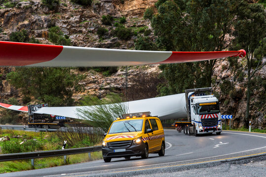 Special transport of an oversized wind turbine blade with pilot escort vehicle on a rural road