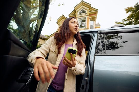 Woman gets out of the car in a rush