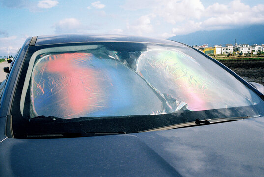 A car on a sunny day with windshield reflectors 