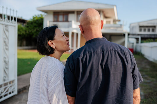 Couple looks at house, perhaps new home.