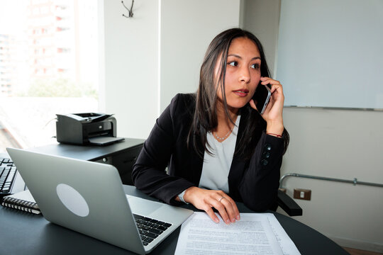 Focused Businesswoman in Phone Conversation at Work